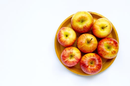 Ripe apples on yellow plate on white background. Copy space