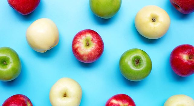 Fresh apples on blue background.
