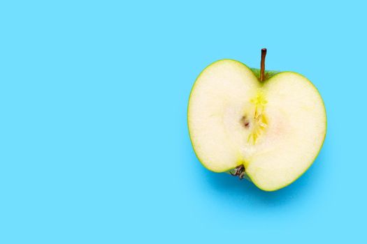 Fresh half green apple on blue background. Top view