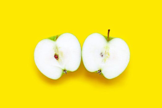 Fresh green apple on yellow background. Top view