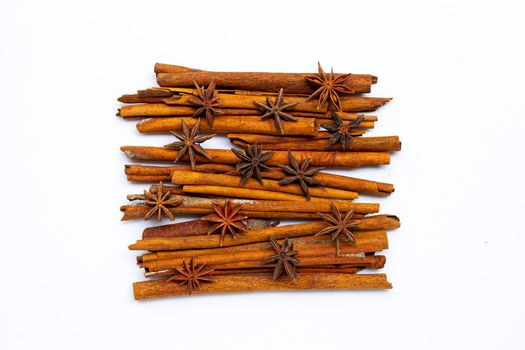 Star anis and cinnamon sticks on white background.