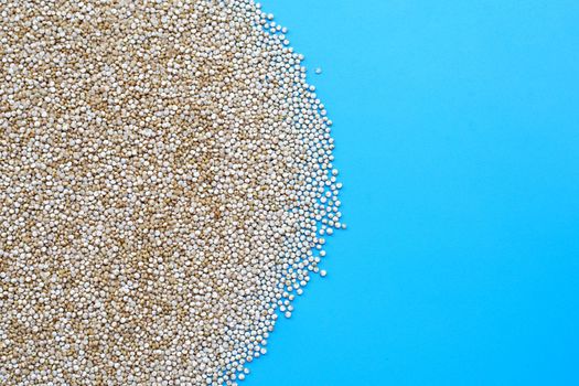 Organic Quinoa on blue background. Copy space