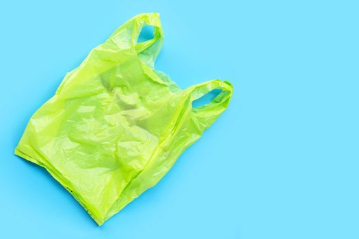 Colorful plastic bags on blue background. Copy space