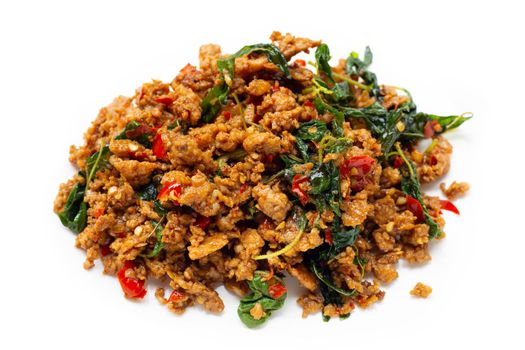 Thai food. Stir-fried minced pork with basil leaves on white background.