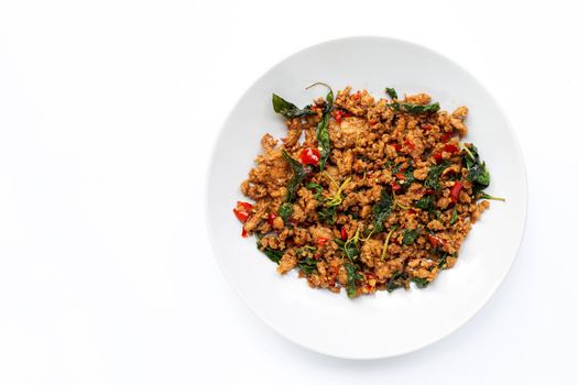 Thai food. Stir-fried minced pork with basil leaves on white background.