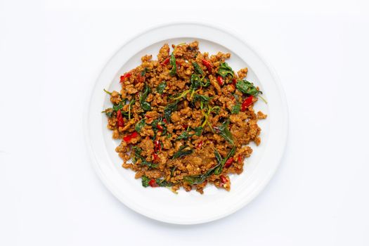 Thai food. Stir-fried minced pork with basil leaves on white background.