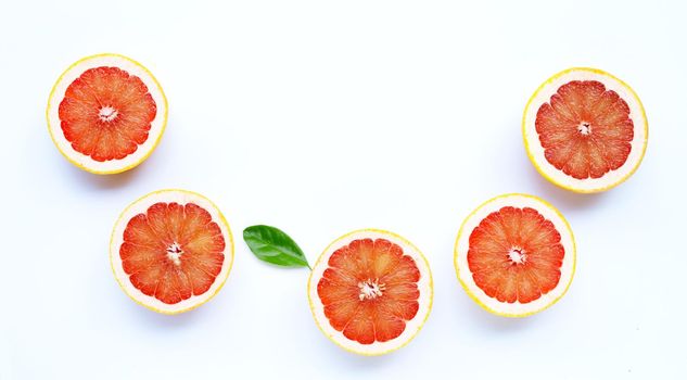 High vitamin C. Juicy grapefruit with leaf on white background.