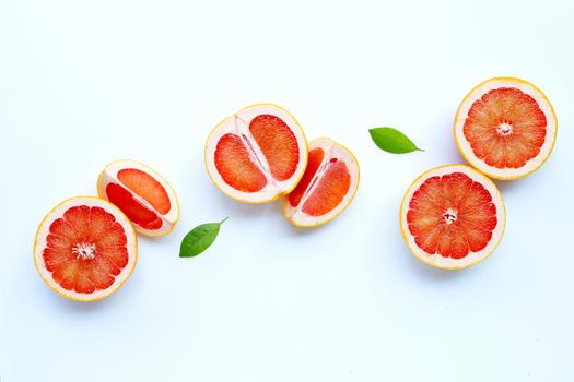 High vitamin C. Juicy grapefruit with leaves on white background.