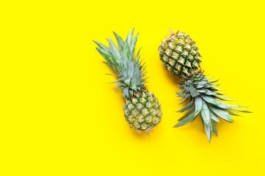 Pineapple on yellow background. Copy space