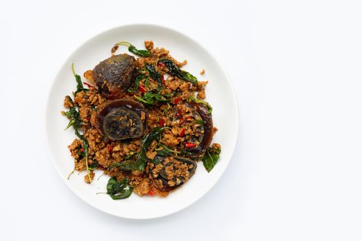 Thai food. Stir-fried minced pork, preserved egg  with basil leaves on white background.