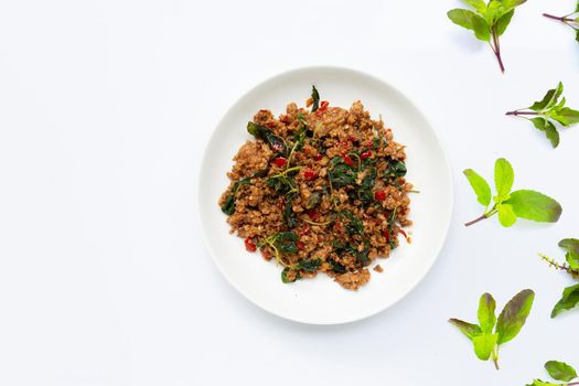 Thai food. Stir-fried minced pork with basil leaves on white background.