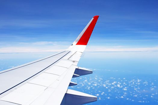 View of sky cloud and wing of airplane from window