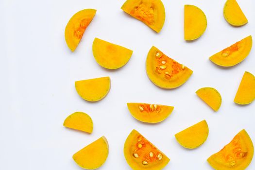 Cut and slices butternut squash on white background.