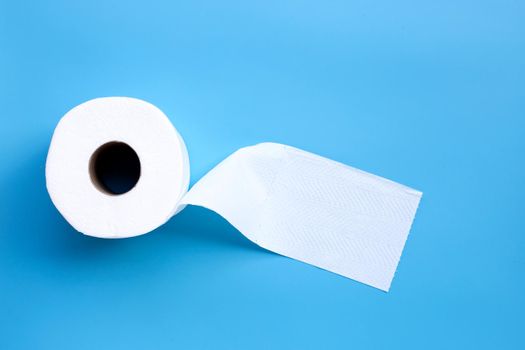 Toilet paper on blue background. Copy space