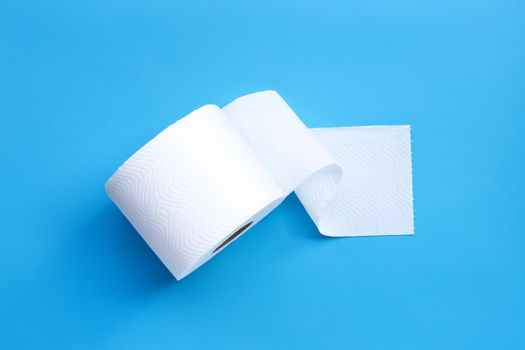 Toilet paper on blue background. Copy space