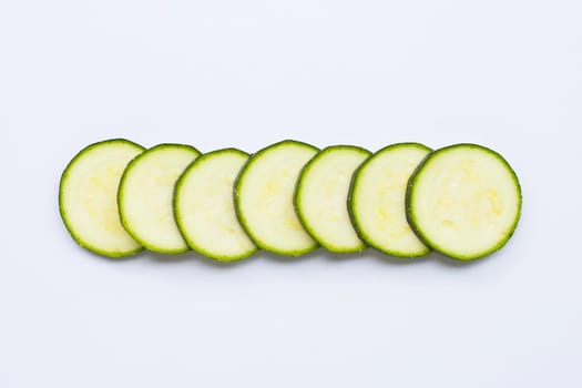 Zucchini slices on white background. Copy space