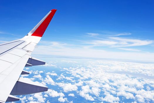 View of cloud and wing of airplane from window