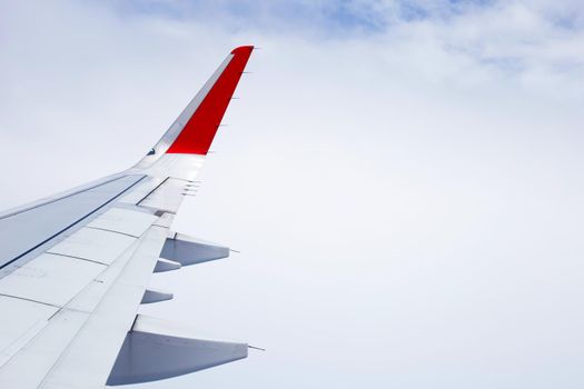 View of cloud and wing of airplane from window