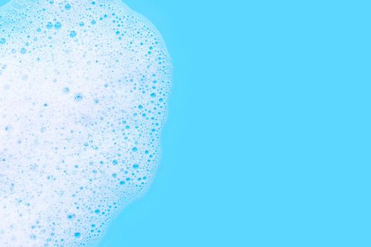 Foam on blue background. Top view