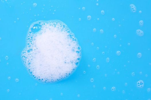 Foam on blue background. Top view