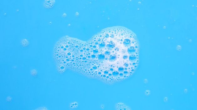 Foam on blue background. Top view