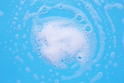 Foam on blue background. Top view