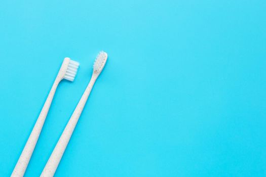 Toothbrushes on blue background. Top view