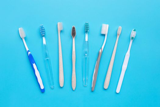 Toothbrushes on blue background. Top view