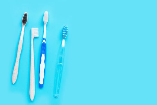 Toothbrushes on blue background. Top view