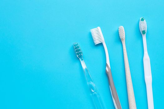 Toothbrushes on blue background. Top view