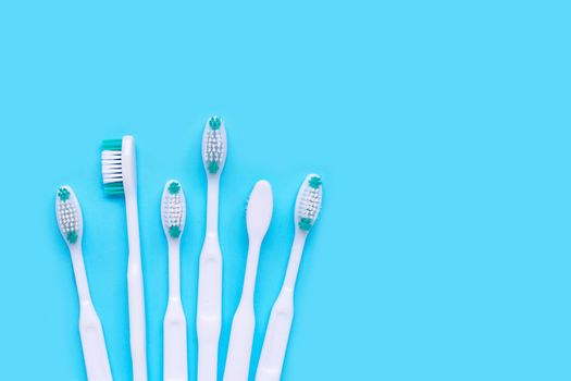 Toothbrushes on blue background. Top view