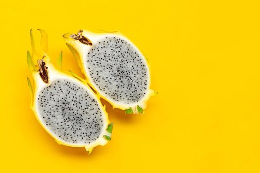 Yellow pitahaya or dragon fruit on yellow background. Copy space
