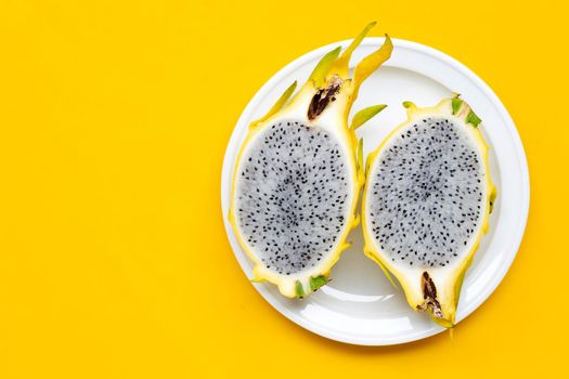 Yellow pitahaya or dragon fruit on yellow background. Copy space
