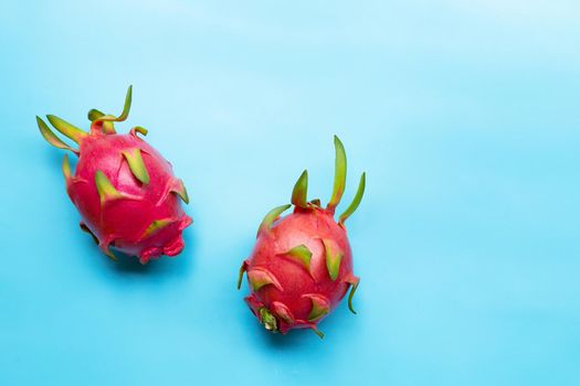 Dragon fruit or pitaya on blue background. Delicious tropical exotic fruit. Top view