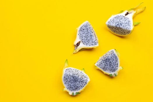 Yellow pitahaya or dragon fruit on yellow background. Copy space