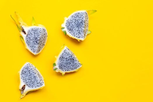 Yellow pitahaya or dragon fruit on yellow background. Copy space