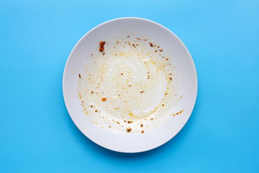 Dirty dish on blue background. Top view