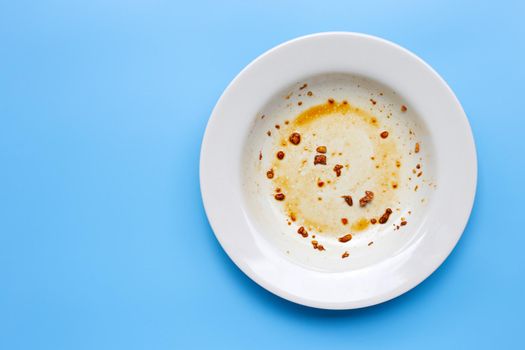 Dirty dish on blue background. Top view