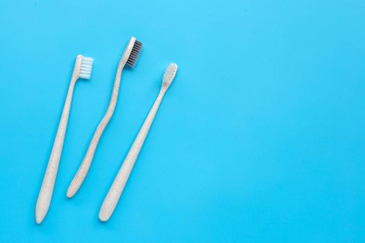 Toothbrushes on blue background. Top view