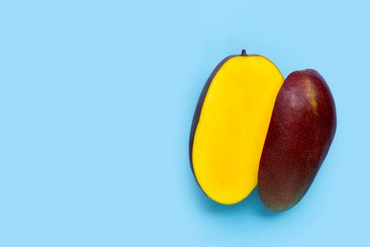 Tropical fruit, Mango on blue background. Top view