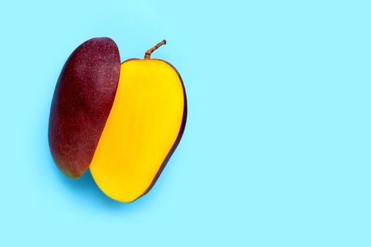 Tropical fruit, Mango on blue background. Top view