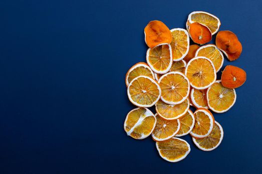 Dried orange slices on dark background.