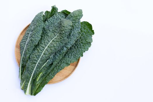Fresh organic green kale leaves on white background.