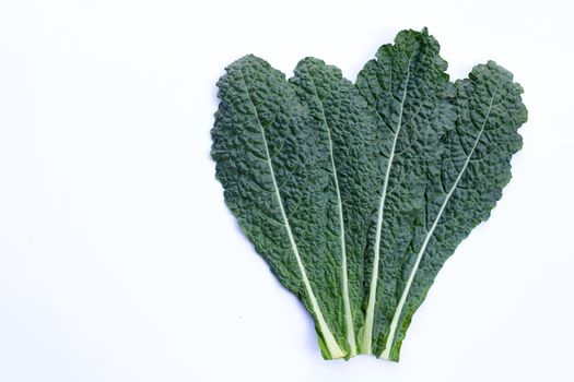 Fresh organic green kale leaves on white background.