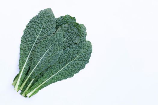 Fresh organic green kale leaves on white background.