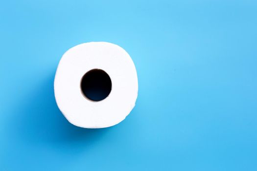 Toilet paper on blue background. Copy space