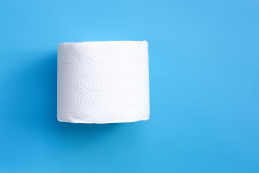Toilet paper on blue background. Copy space