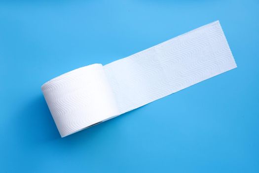 Toilet paper on blue background. Copy space