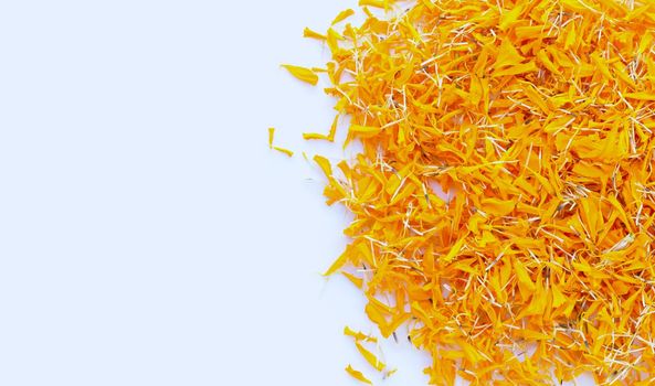 Marigold flower petals on white background.