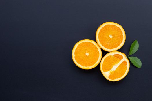 High vitamin C, Juicy and sweet. Fresh orange fruit with green leaves on dark wooden background.